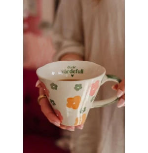 Muki tekstillä kuva